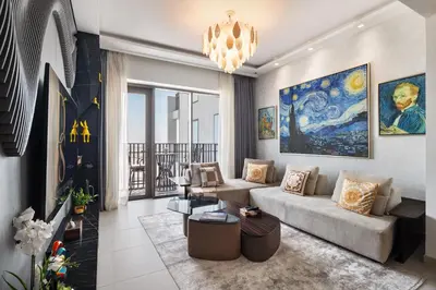 a living room with a couch and a chandelier at Waterfront Apartment at Dubai Creek Harbour - By DuStay in Dubai
