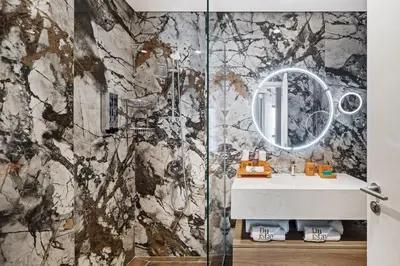 a bathroom with a shower with a sink and a mirror at Community view home-Dubai Creek Harbour - By DuStay in Dubai