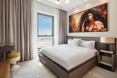 a bedroom with a bed and a painting on the wall at Community view home-Dubai Creek Harbour - By DuStay in Dubai