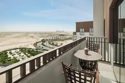 a balcony with a table and chairs and a view at Community view home-Dubai Creek Harbour - By DuStay in Dubai