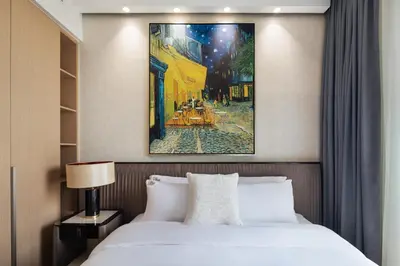 a bedroom with a bed and a painting on the wall at Luxurious Apartment, Dubai Creek Harbour - By Dustay in Dubai