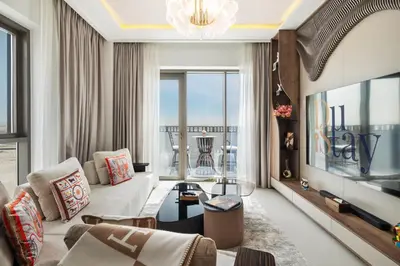 a living room with a couch and a tv at Elegant Apartment for Relaxation, Creek Harbour - By DuStay in Dubai