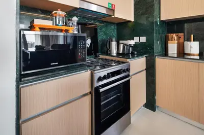 a kitchen with a microwave and a stove top oven at Elegant Apartment for Relaxation, Creek Harbour - By DuStay in Dubai