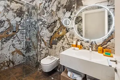 a bathroom with a sink and a mirror at Elegant Apartment for Relaxation, Creek Harbour - By DuStay in Dubai