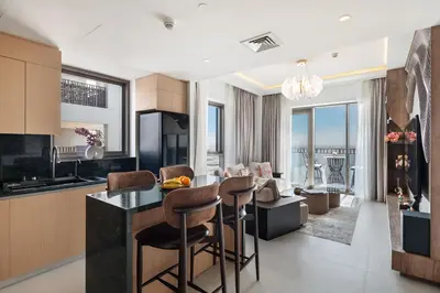 a kitchen and living room with a table and chairs at Elegant Apartment for Relaxation, Creek Harbour - By DuStay in Dubai