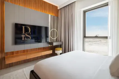 a bedroom with a bed and a flat screen tv at Elegant Apartment for Relaxation, Creek Harbour - By DuStay in Dubai