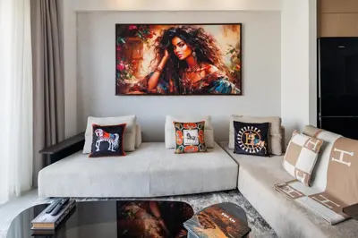 a living room with a large painting on the wall at Dubai Creek Poolside view Apartment - By DuStay in Dubai