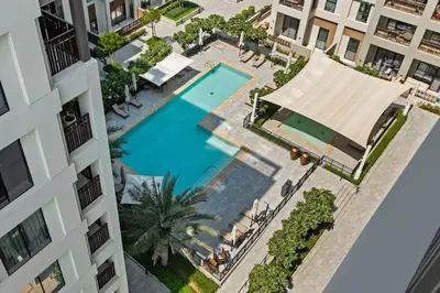 an overhead view of a swimming pool in a building at Dubai Creek Poolside view Apartment - By DuStay in Dubai