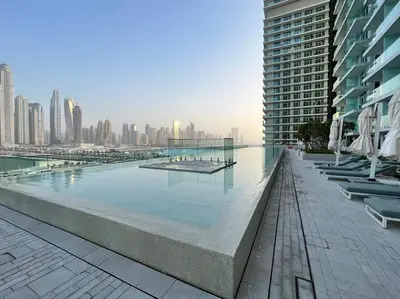 a large swimming pool in the middle of a city at FIRST CLASS 1BR Stunning Marina & Palm View in Dubai