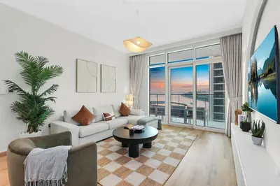 a living room with a couch and a table at FIRST CLASS 1BR Stunning Marina & Palm View in Dubai