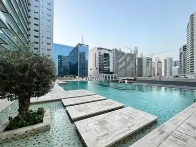 a large swimming pool in the middle of a city at GuestReady - Luxurious studio in Business Bay in Dubai