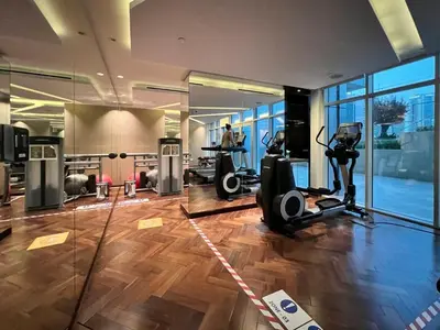 a gym with treadmills and ellipticals in a building at GuestReady - Luxurious studio in Business Bay in Dubai