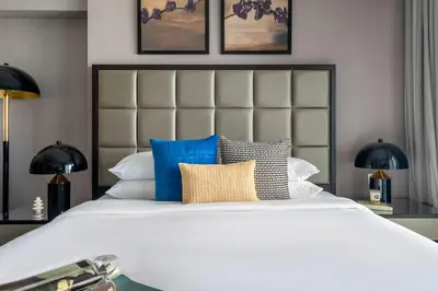 a bedroom with a large white bed with blue pillows at GuestReady - Luxurious studio in Business Bay in Dubai