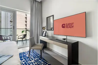 a room with a tv and a bed and a desk at GuestReady - Luxurious studio in Business Bay in Dubai