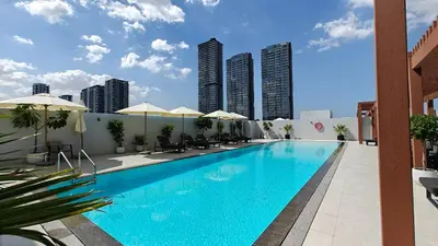 a large swimming pool on top of a building at New Charming Studio in JVC in Dubai