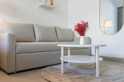 a living room with a couch and a table at New Charming Studio in JVC in Dubai