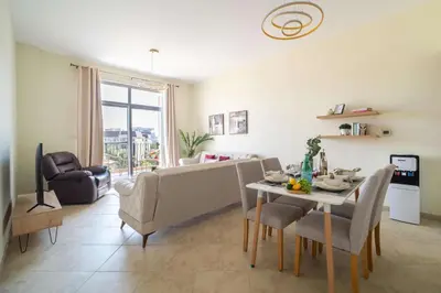 a living room with a table and a couch at Frank Porter - Widcombe House 3 in Dubai