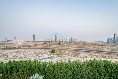 a view of a city with a ferris wheel in the background at Modern 1BR Apartment in Binghatti Luna, Jumeirah Village Circle by Deluxe Holiday Homes in Dubai