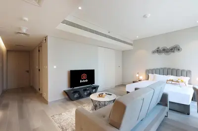 a hotel room with a bed and a fireplace at Livbnb -Glam Studio in Marina Next to Marina Walk in Dubai
