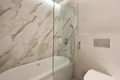 a bathroom with a shower and a tub and a toilet at Livbnb -Glam Studio in Marina Next to Marina Walk in Dubai