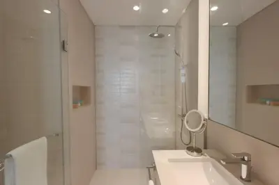 a bathroom with a shower and a toilet and a sink at Livbnb-Beachfront 3BR with Marina Harbour Panorama in Dubai
