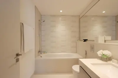 a bathroom with a tub and a toilet and a sink at Livbnb-Beachfront 3BR with Marina Harbour Panorama in Dubai