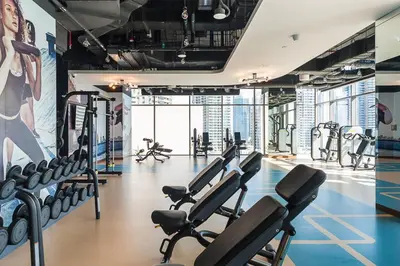 a gym with cardio equipment in a building at 2BR Sunset View Suite -Jumeirah Living Marina Gate in Dubai