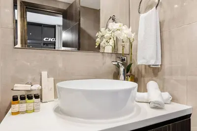 a bathroom with a white sink and a mirror at Luxury 1BR in Business Bay - Close to Dubai Mall, Burj Khalifa & City Sights in Dubai