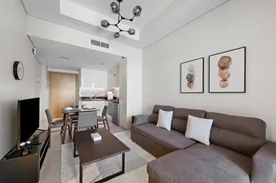 a living room with a couch and a table at Modern 2-Bedroom Apartment in Aykon Tower C in Dubai