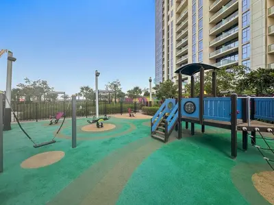 a playground with a slide and swings at Modern 2-Bedroom Apartment in Aykon Tower C in Dubai