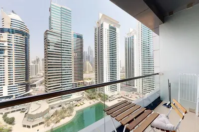 a balcony with a bench and a view of a city at Fabulous Studio in JLT with Lake View in Dubai