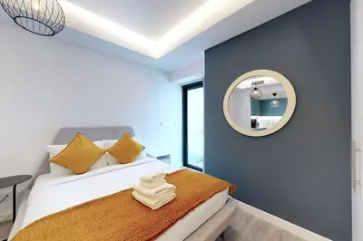 a bedroom with a bed with a mirror on the wall at Fabulous Studio in JLT with Lake View in Dubai