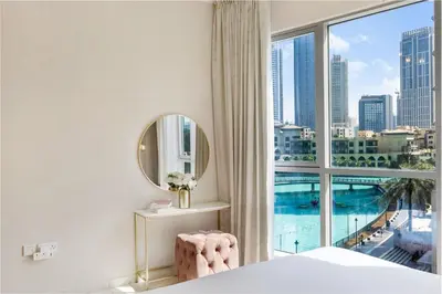 a bedroom with a large window with a view of the city at Durrani Homes - The Luxe 3br with Burj Khalifa and Fountain View - third room without partition in Dubai