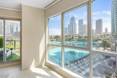 a room with windows and a view of the city at Durrani Homes - The Luxe 3br with Burj Khalifa and Fountain View - third room without partition in Dubai