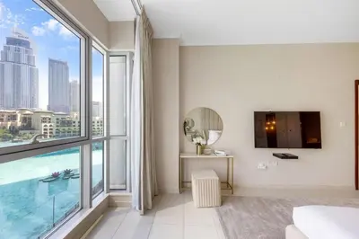 a bedroom with a large window with a view of the city at Durrani Homes - The Luxe 3br with Burj Khalifa and Fountain View - third room without partition in Dubai