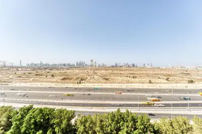 an aerial view of a parking lot with cars at Stylish Studio with Pool, Gym & Tasteful Decor in Dubai