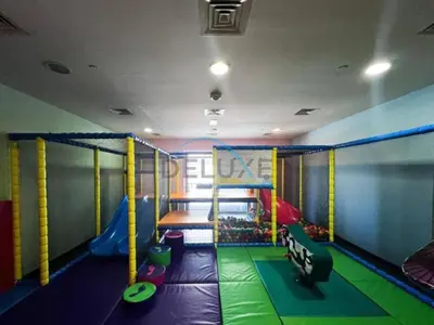 a childrens play room with a slide and a playground at Panoramic 2BR Apartment in Princess Tower, Dubai Marina by Deluxe Holiday Homes in Dubai