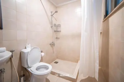 a bathroom with a toilet and a shower at Lux 5BR Villa with Pool & Beach Access in Palm Jumeirah in Dubai