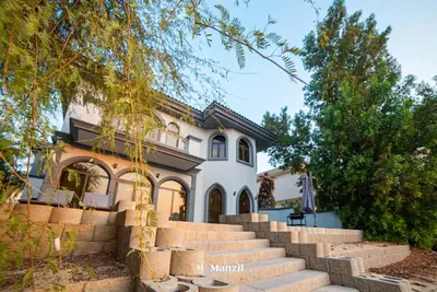 a house with stairs in front of it at Lux 5BR Villa with Pool & Beach Access in Palm Jumeirah in Dubai