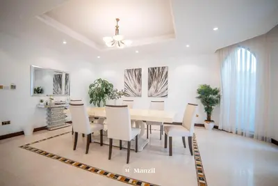 a dining room with a table and chairs at Lux 5BR Villa with Pool & Beach Access in Palm Jumeirah in Dubai
