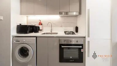 a kitchen with a sink and a washing machine at PREMIER STUDIO I Poolside in Dubai