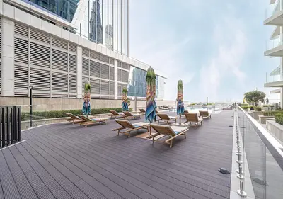 a group of chairs and umbrellas on a deck at Brand new Studio in Business Bay, Missoni Tower in Dubai
