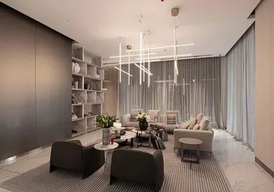 a living room with a couch and a table and chairs at Brand new Studio in Business Bay, Missoni Tower in Dubai
