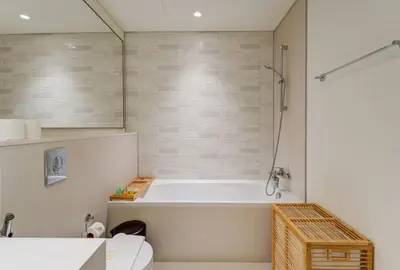 a bathroom with a tub and a toilet at Private Beachfront 2 Bed With 180 Marina Skyline in Dubai