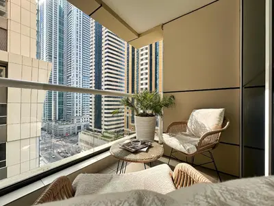 an apartment balcony with a view of a city at Trophy Starlight Suites Lux Upgraded 1BR in Marina in Dubai