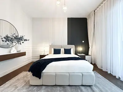 a bedroom with a white bed and a black wall at Trophy Starlight Suites Lux Upgraded 1BR in Marina in Dubai
