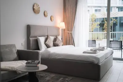 a bedroom with a bed and a couch and a table at Luma Escape Dubai in Dubai