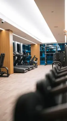 a gym with a row of treadmills and chairs at Luma Escape Dubai in Dubai