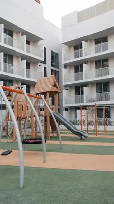 a playground with a slide in front of a building at Luma Escape Dubai in Dubai