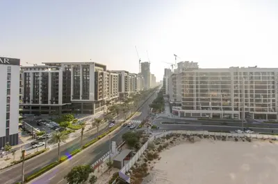 a view of a city with a river and buildings at Livbnb - Stylish 1B in Park Heights Dubai Hills in Dubai